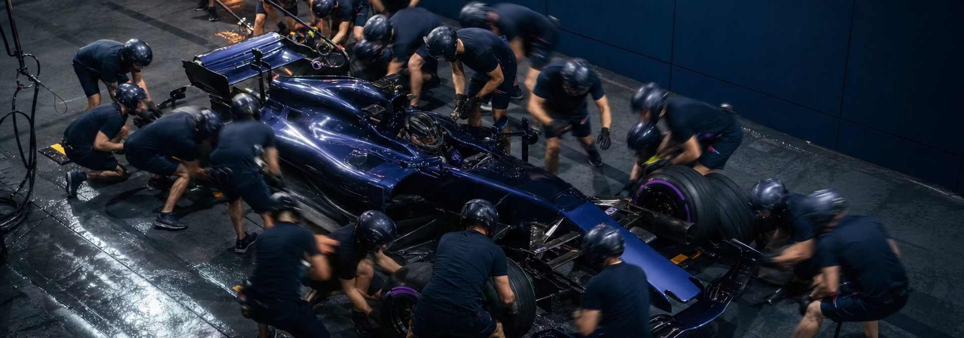 Pit crew working together on a race car